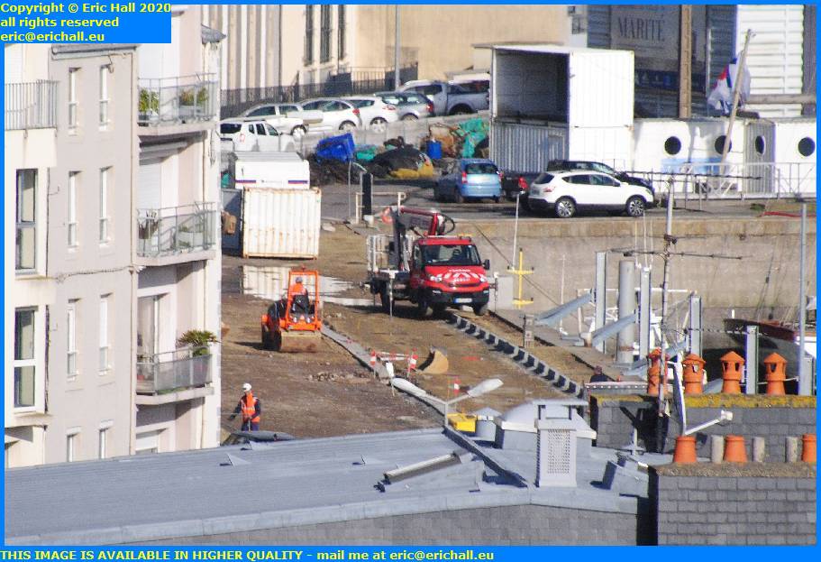 men working concrete strip parking rue du port de granville harbour manche normandy france eric hall