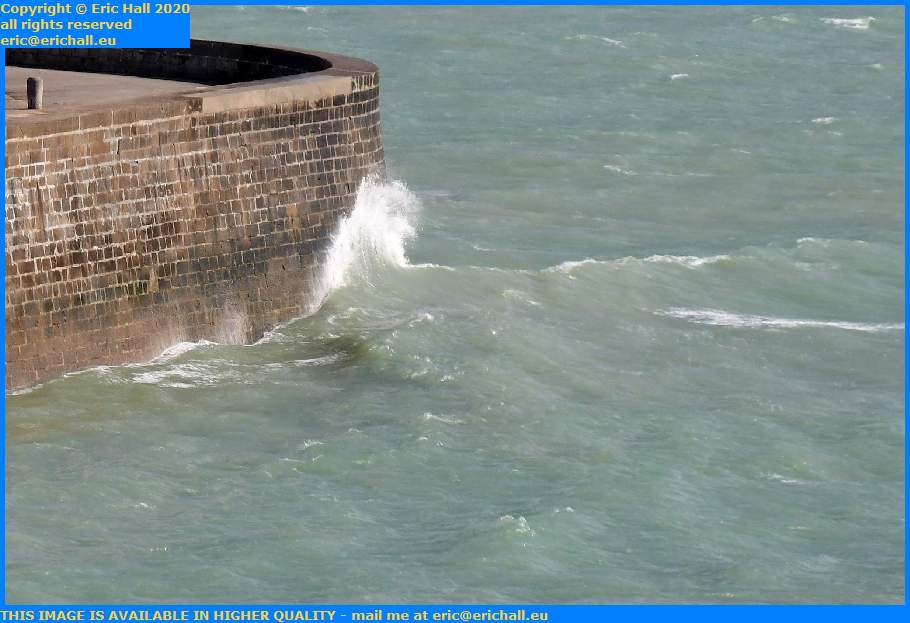 storm waves crashing on sea wall port de granville harbour manche normandy france eric hall