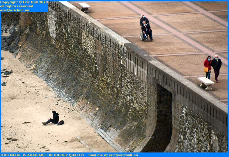 man sitting on beach people in wheelchair plat gousset Granville Manche Normandy France Eric Hall