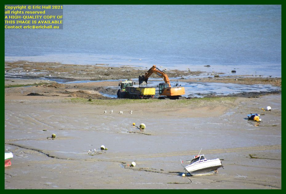 digger clearing sandbank entrance to port de Granville harbour Manche Normandy France photo Eric Hall April 2021