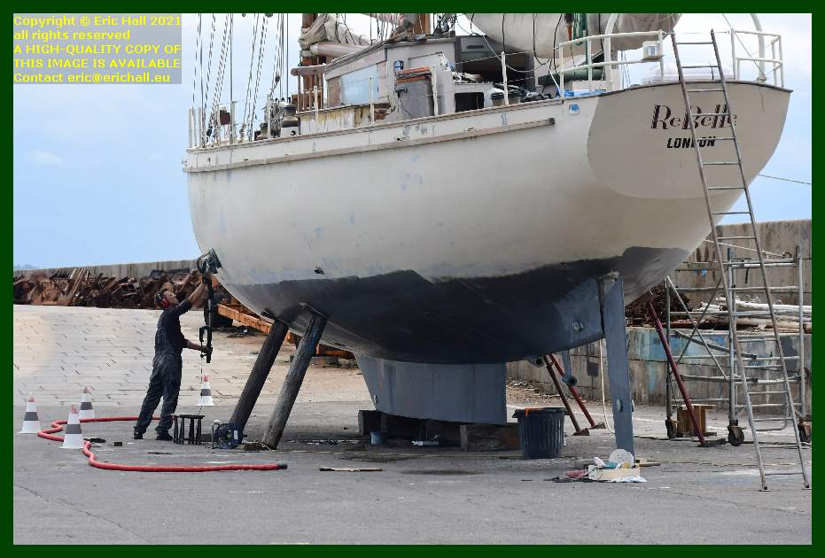 sanding down of hull yacht rebelle chantier navale port de Granville harbour Manche Normandy France Eric Hall