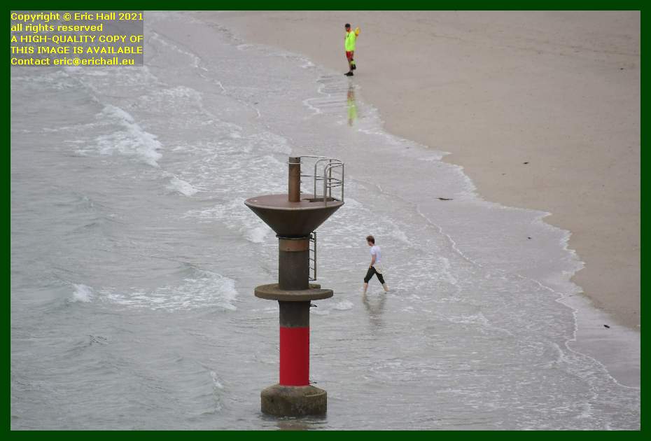 lifeguard watching man entering water by diving platform plat gousset Granville Manche Normandy France Eric Hall