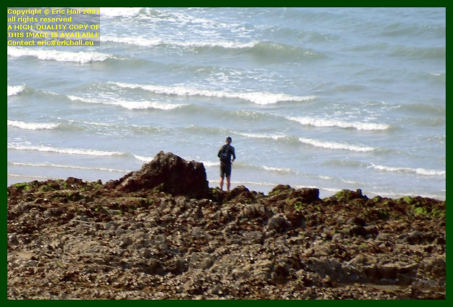 man fishing from rocks pointe du roc Granville Manche Normandy France photo Eric Hall august 2021