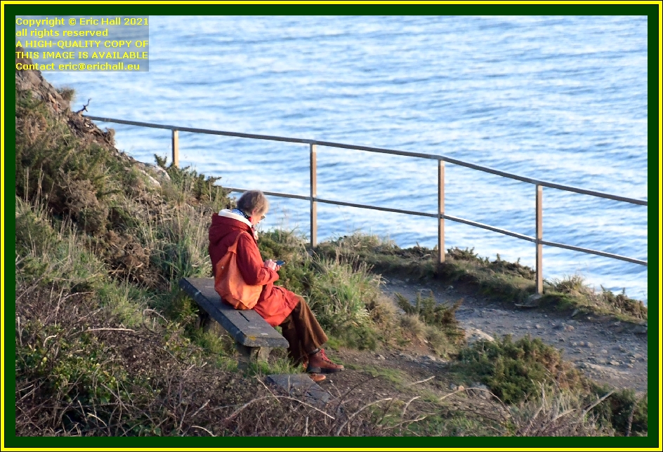 woman sitting on bench pointe du roc Granville Manche Normandy France Eric Hall photo December 2021