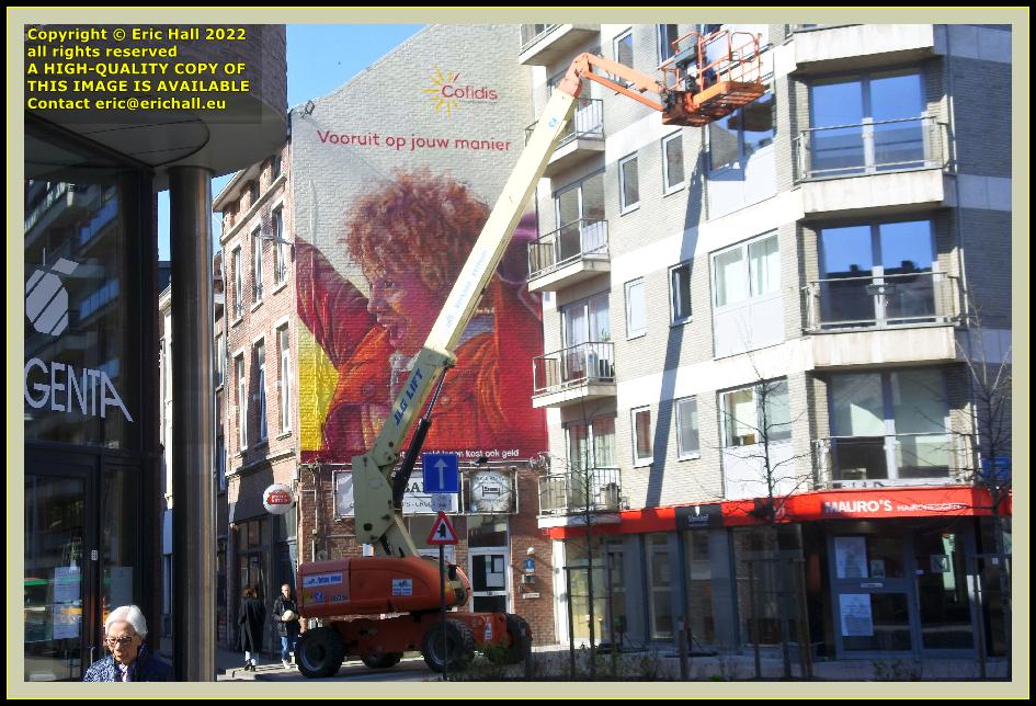 cleaning balcony with cherry picker mural brusselsestraat Leuven Belgium Eric Hall photo March 2022