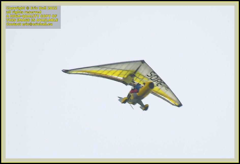 yellow powered hang glider pointe du roc Granville Manche Normandy France Eric Hall photo April 2022