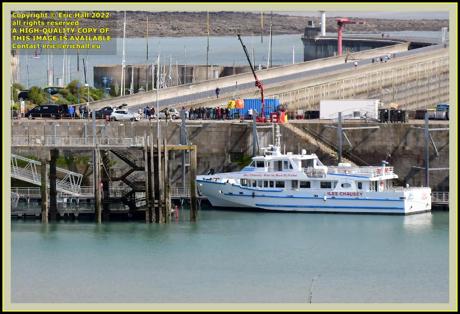 people on sea wall joly france ferry terminal port de Granville harbour Manche Normandy France Eric Hall photo April 2022