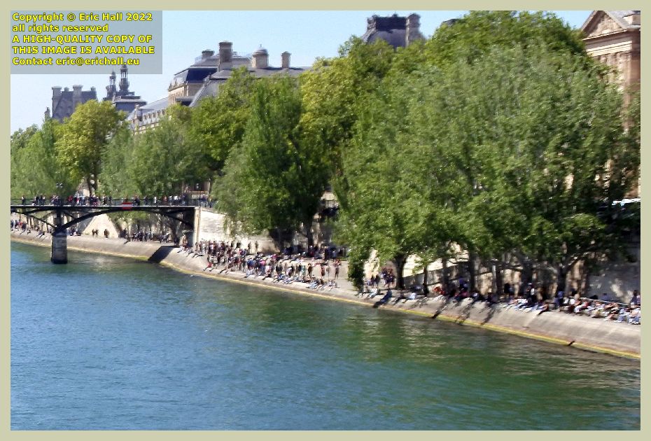 crowds on river seine bank listening to jazz musicians paris  France Eric Hall photo April 2022