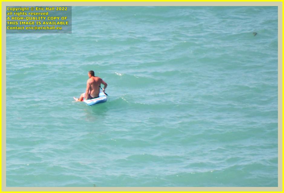 man on paddle board baie de Granville France Eric Hall photo July 2022