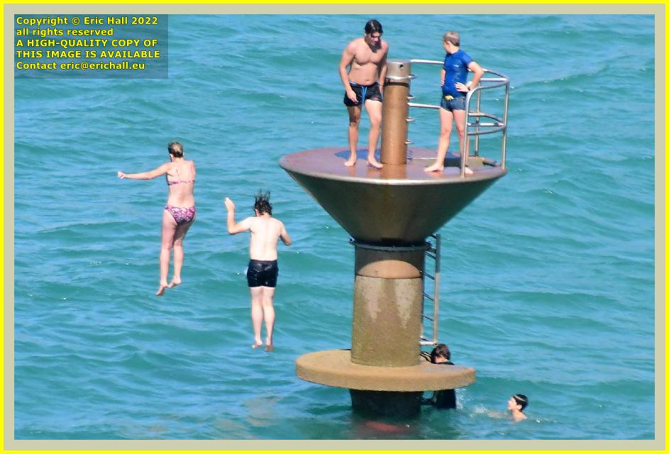 people jumping from diving platform plat gousset Granville Manche Normandy France Eric Hall photo August 2022