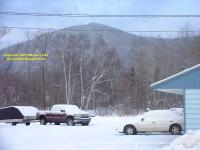 motel Colebrook New Hampshire with snow-covered Cavalier and snow-covered mountain in the background
